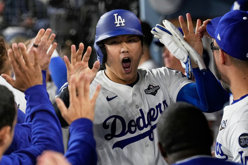 Los Angeles Dodgers' Shohei Ohtani celebrates in the dugout after scoring against the Toronto Blue Jays during the fifth inning in Game 3 of baseball's World Series, Monday, Oct. 27, 2025, in Los Angeles. (AP Photo/Brynn Anderson) Los Angeles Dodgers' Shohei Ohtani celebrates in the dugout after scoring against the Toronto Blue Jays during the fifth inning in Game 3 of baseball's World Series, Monday, Oct. 27, 2025, in Los Angeles. (AP Photo/Brynn Anderson)