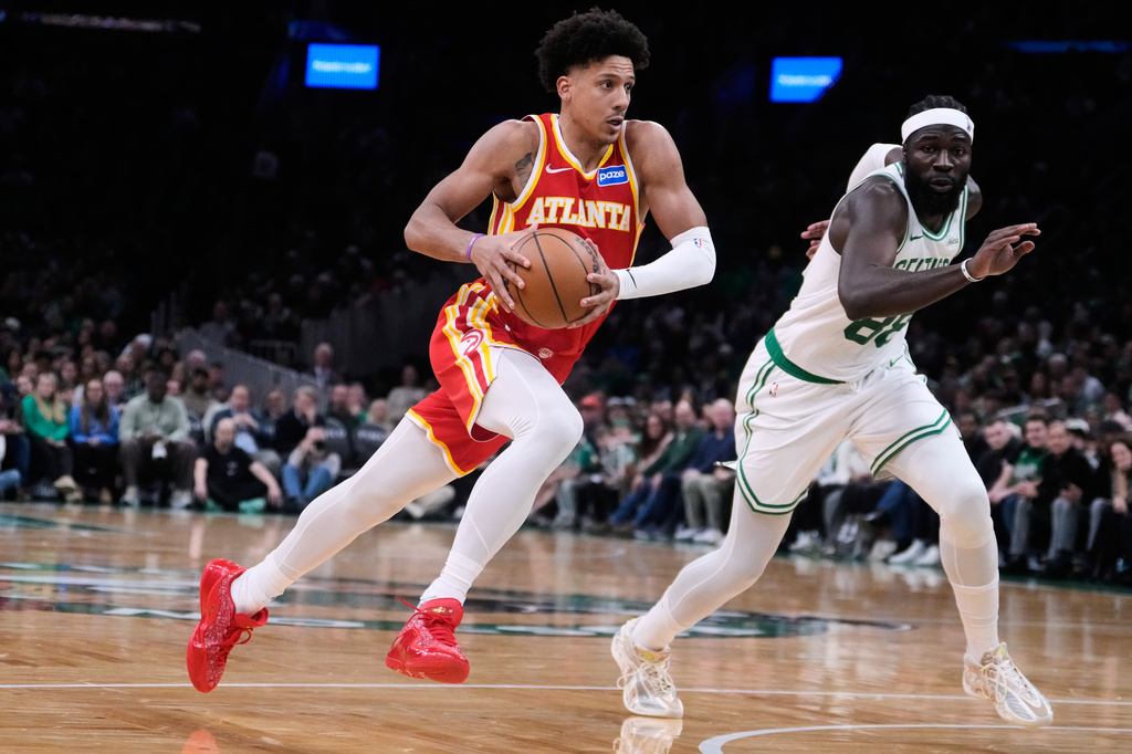 Atlanta Hawks forward Jalen Johnson drives to the basket against Boston Celtics center Neemias Queta during the second half of an NBA basketball game, Friday, March 27, 2026, in Boston. (AP Photo/Charles Krupa)