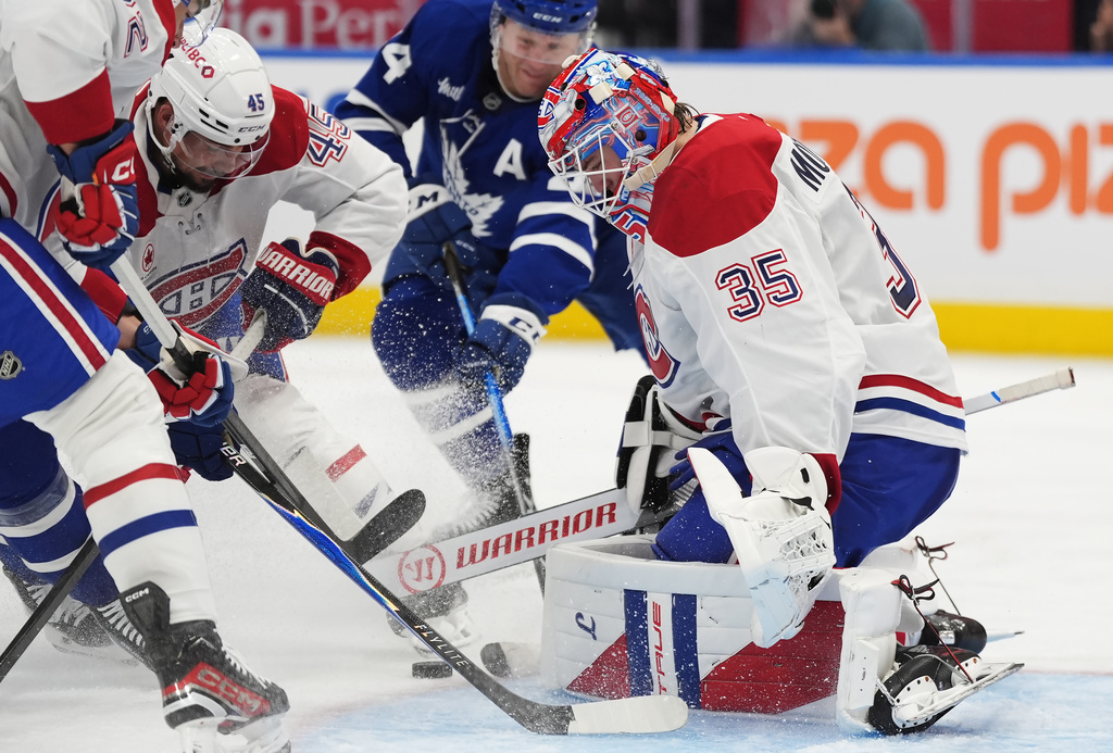 Montreal Canadiens goaltender Sam Montembeault (35) makes a save against the Toronto Maple Leafs during second period NHL hockey action in Toronto on Wednesday, Oct. 8, 2025. (Frank Gunn/The Canadian Press via AP)