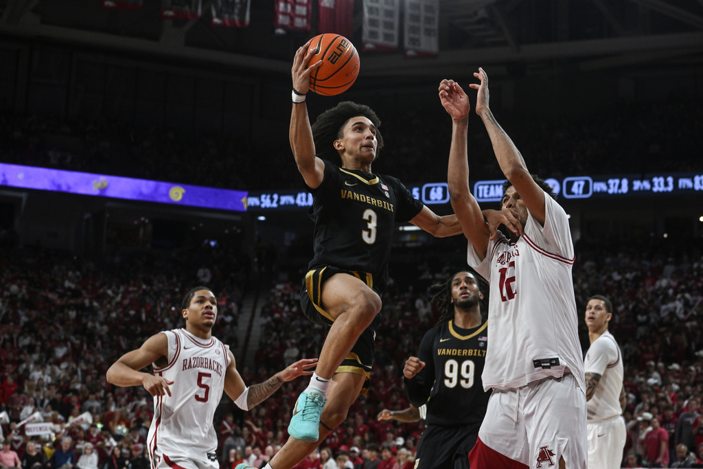 Vanderbilt guard Tyler Tanner (3) tries to shoot over Arkansas forward Malique Ewin (12) during the first half of an NCAA college basketball game Tuesday, Jan. 20, 2026, in Fayetteville, Ark. (AP Photo/Michael Woods)