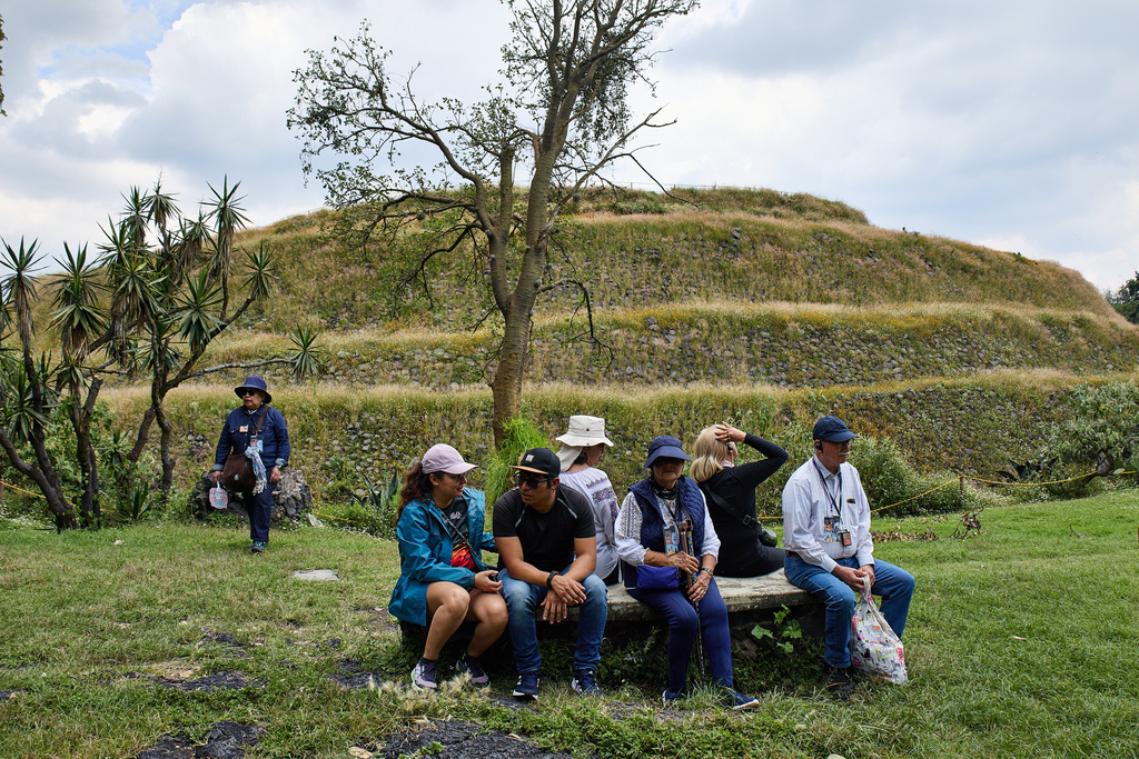 Tourists sit by the Great Basement of the Cuicuilco Archaeological Zone during a tour organized by the National Institute of Anthropology and History in Mexico City, Sunday, Oct. 5, 2025. (AP Photo/Ginnette Riquelme)