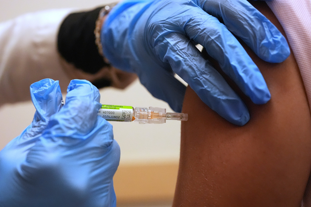 FILE - Pharmacy manager Aylen Amestoy administers a patient with a seasonal flu vaccine at a CVS Pharmacy in Miami, Tuesday, Sept. 9, 2025. (AP Photo/Rebecca Blackwell, File)