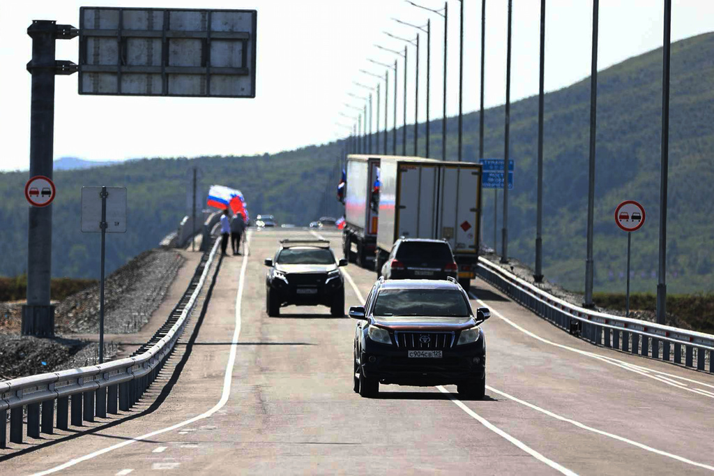 In this photo released by the Government of Primorsky Krai Region on Monday, Sept. 7, 2026, vehicles drive across the new bridge between Russia and North Korea named after the Soviet officer Yakov Novichenko, who is credited with saving North Korea's founding leader, Kim Il-sung, over the Tumannaya River in Primorsky Krai Region of Russia. (Dmitry Ignatenko/Government of Primorsky Krai Region via AP)