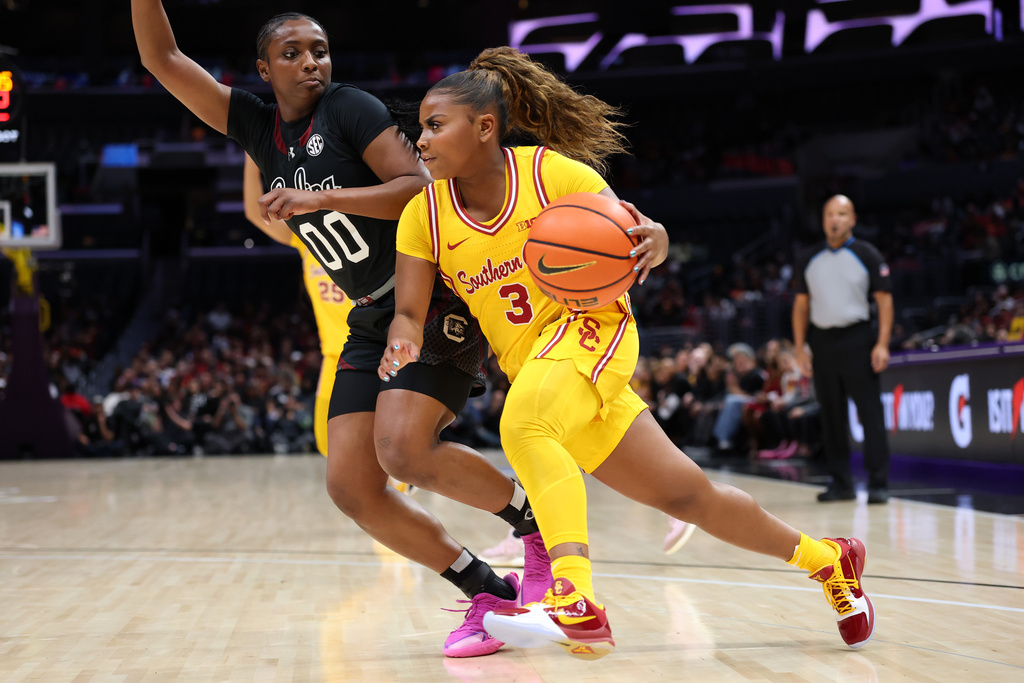 South Carolina guard Ta'Niya Latson (00) defends against Southern California guard Gwen Jenkins (3) during the first half of an NCAA college basketball game Saturday, Nov. 15, 2025, in Los Angeles. (AP Photo/Allison Dinner)