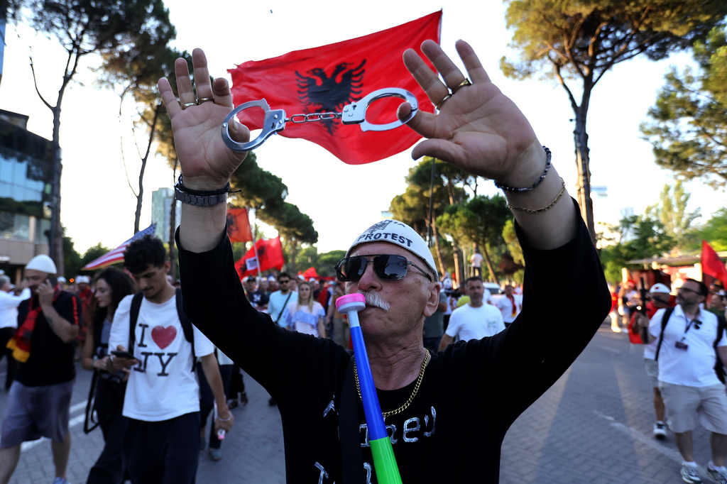 A protester takes part in a rally against plans for a luxury construction project linked to U.S. President Donald Trump's son-in-law, Jared Kushner, in Tirana, Albania, Saturday, July 4, 2026.(AP Photo/Hameraldi Agolli)