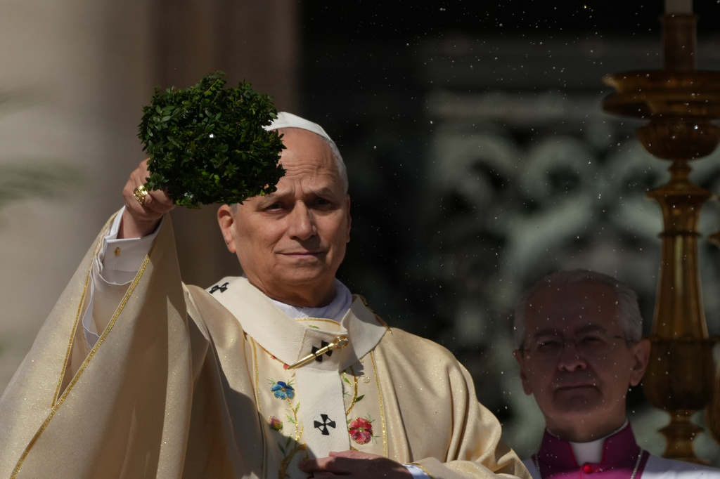 Pope Leo XIV sprinkles holy water with a bunch of hyssop sprigs as he presides over Easter Mass in St. Peter’s Square at the Vatican, Sunday, April 5, 2026. (AP Photo/Andrew Medichini)