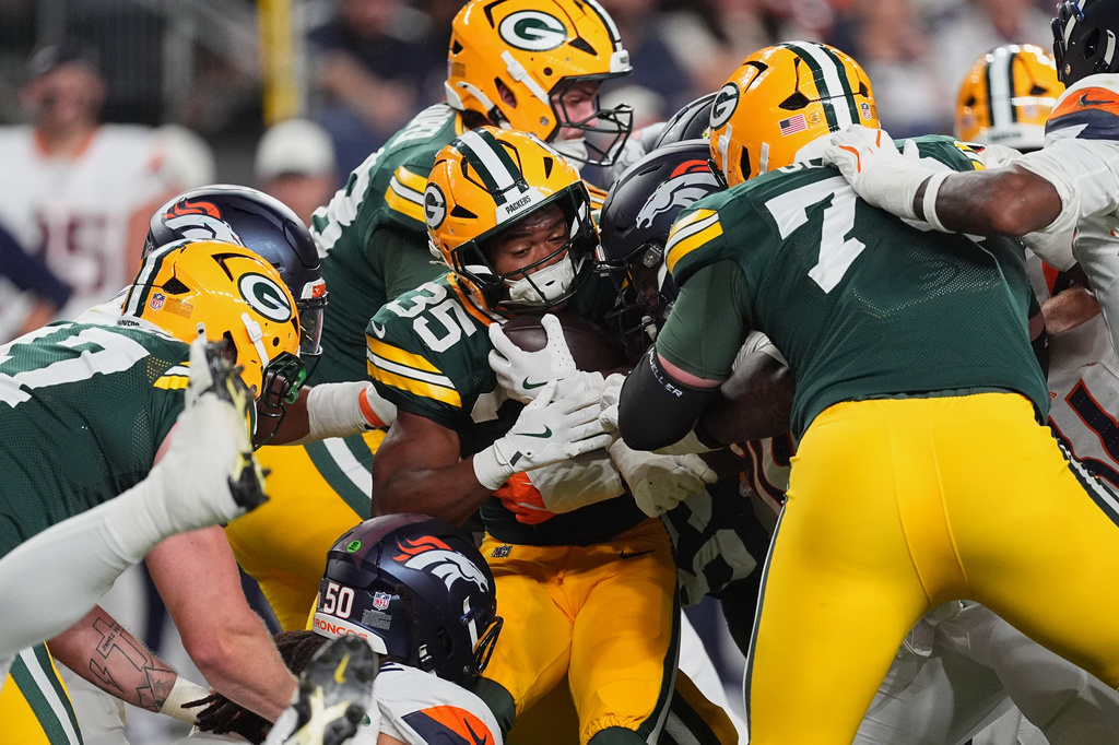 Green Bay Packers running back Jaden Nixon (35) is tackled against the Denver Broncos during the second half of an NFL preseason football game Friday, Aug. 21, 2026, in Denver. (AP Photo/David Zalubowski)