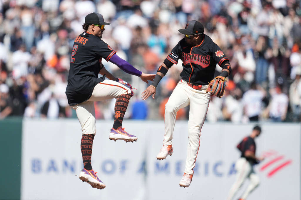 San Francisco Giants shortstop Willy Adames, left, celebrates with second baseman Luis Arraez after a baseball game against the Chicago White Sox Saturday, May 23, 2026, in San Francisco. (AP Photo/Jeff Chiu)