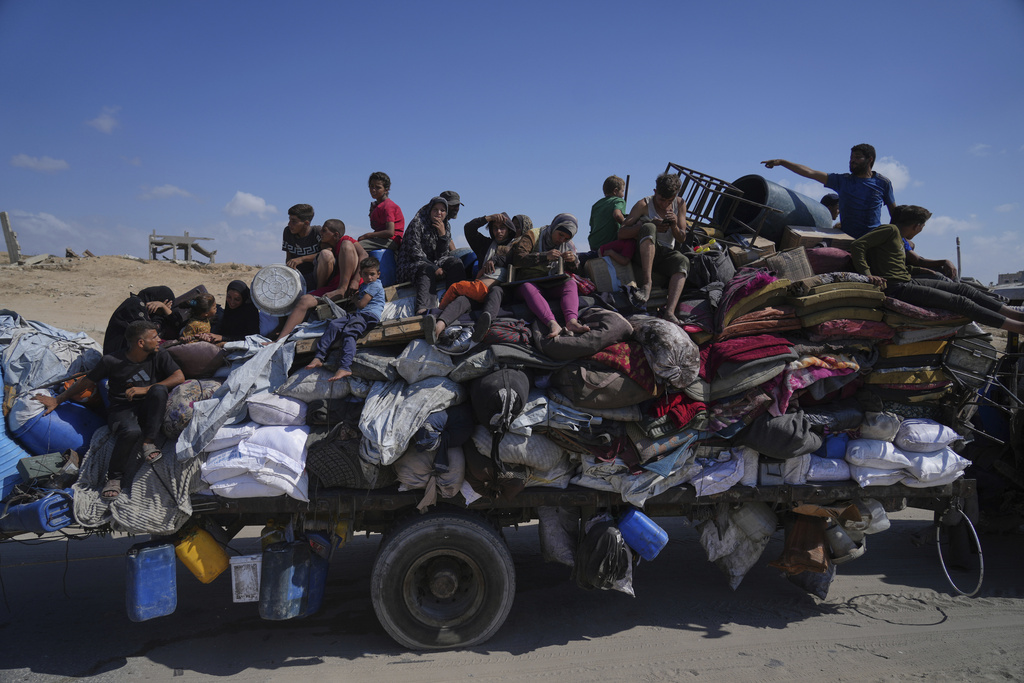 Displaced Palestinians fleeing northern Gaza carry their belongings along the coastal road toward southern Gaza, Tuesday, Sept. 9, 2025, after the Israeli army issued evacuation orders from Gaza City. (AP Photo/Jehad Alshrafi)