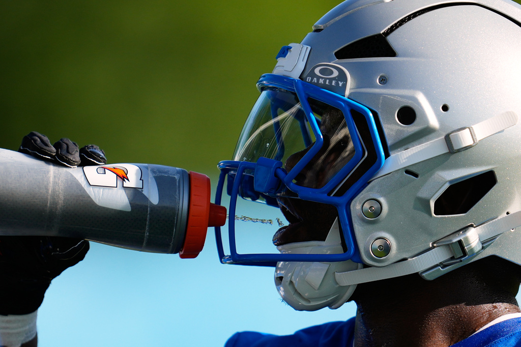 Detroit Lions running back Jabari Small drinks water to cool off from the heat during a NFL football training camp practice in Allen Park, Mich., Wednesday, July 29, 2026. (AP Photo/Paul Sancya)