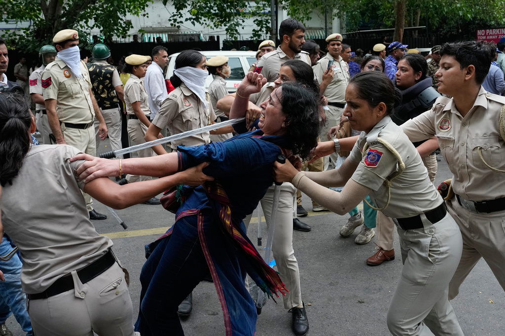 Police detains a supporter of the Cockroach Janta Party as they attempt to march toward India's Parliament, demanding the resignation of the education minister, in New Delhi, India, Monday, July 20, 2026.(AP Photo/Manish Swarup)