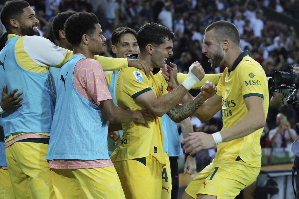 AC Milan's Christian Pulisic, second from right, celebrates with teammates after scoring his team's third goal during the Serie A soccer match between Udinese and AC Milan at the Bluenergy Stadium in Udine, Italy, Saturday, Sept. 20, 2025. (Andrea Bressanutti/LaPresse via AP)