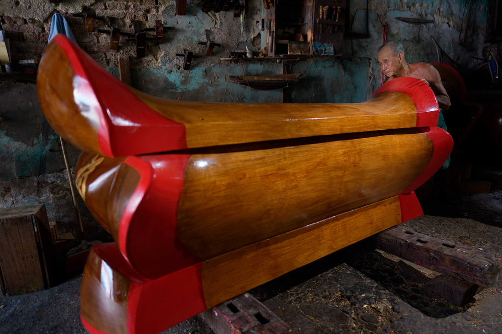 Goh Khuay Par inspects a completed Mei Hua coffin at his workshop in Muar, Malaysia, Monday, Sept. 7, 2026. (AP Photo/Vincent Thian)