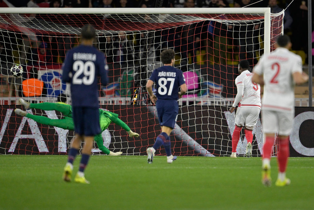 Monaco's Folarin Balogun, second right, scores the opening goal during the first-leg of the Champions League playoff soccer match between Monaco and Paris Saint-Germain in Monaco, Tuesday, Feb. 17, 2026. (AP Photo/Philippe Magoni)
