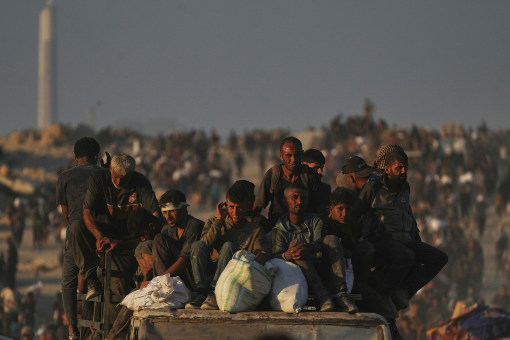 FILE - Palestinians carry sacks of flour unloaded from a humanitarian aid convoy that reached Gaza City from the northern Gaza Strip, Sunday, Aug. 24, 2025. (AP Photo/Abdel Kareem Hana, File)