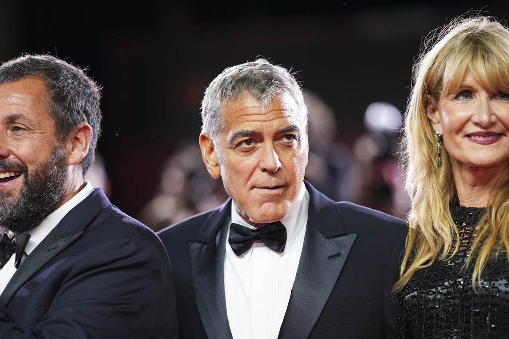 Adam Sandler, from left, George Clooney, and Laura Dern pose for photographers at the red carpet for the film 'Jay Kelly' during the 82nd edition of the Venice Film Festival in Venice, Italy, on Thursday, Aug. 28, 2025. (Photo by Scott A Garfitt/Invision/AP)