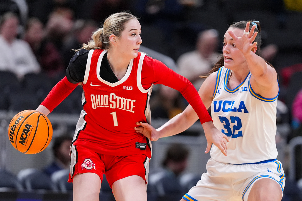 UCLA forward Angela Dugalic (32) defends Ohio State forward Kylee Kitts (1) in the second half of an NCAA college basketball game in the semifinals of the Big Ten Conference tournament, Saturday, March 7, 2026 in Indianapolis. (AP Photo/Michael Conroy)