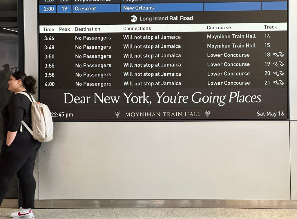 A passenger waits by a sign board showing no Long Island Rail Road trains operating at the Moynihan Train Hall section of Penn Station on the first day of a strike on Saturday, May 16, 2026 in New York. (AP Photo/Michael R. Sisak)