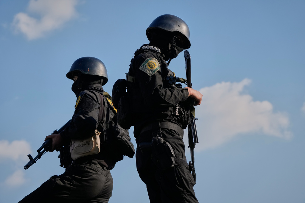 Iranian police special forces stand guard during a funeral procession for Alireza Tangsiri, head of Iran's Islamic Revolutionary Guard Corps Navy, and others killed in Israeli strikes in late March, in Tehran, Iran, Wednesday, April 1, 2026. (AP Photo/Vahid Salemi)