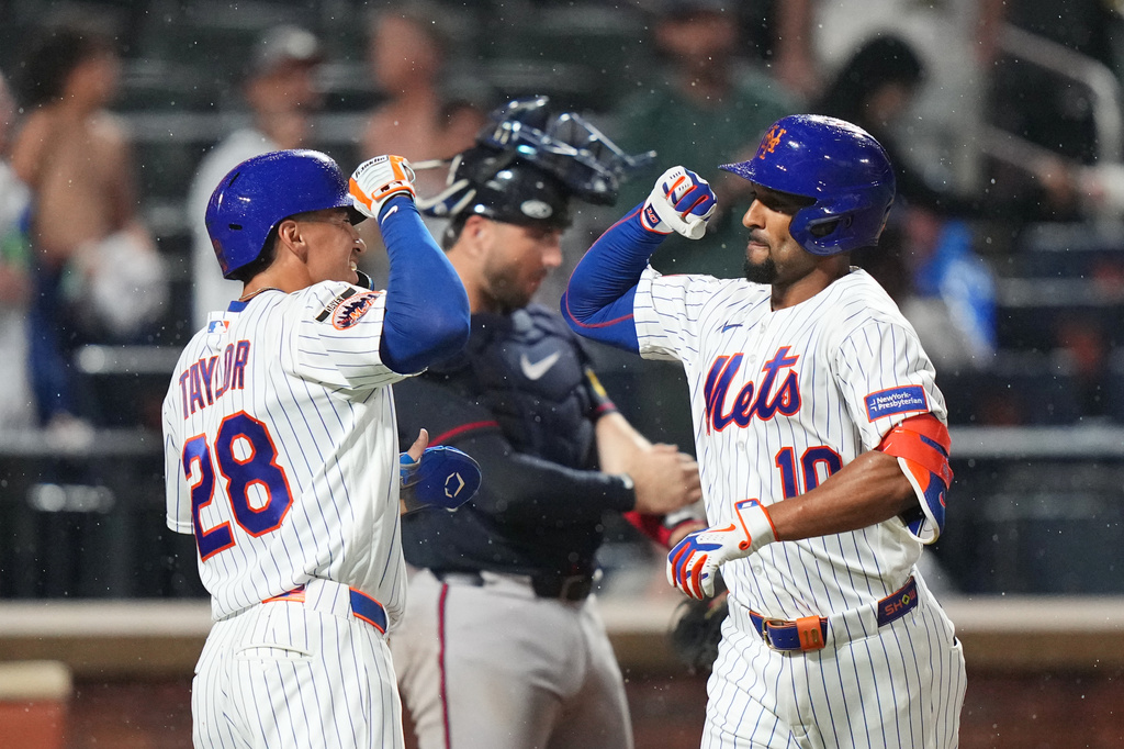 New York Mets' Marcus Semien (10) celebrates with Tyrone Taylor (28) after hitting a two-run home run during the sixth inning of a baseball game Monday, July 27, 2026, in New York. (AP Photo/Frank Franklin II)