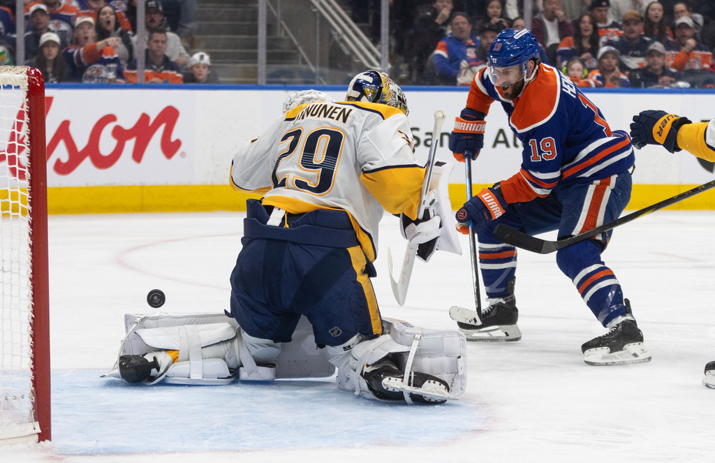 Nashville Predators goalie Justus Annunen (29) makes a save on Edmonton Oilers' Adam Henrique (19) during second period NHL action in Edmonton on Sunday, March 15, 2026. (Jason Franson/The Canadian Press via AP)