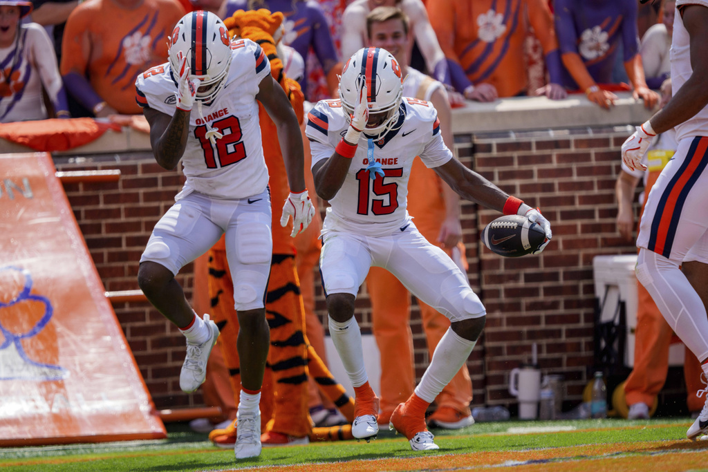 Syracuse wide receiver Darrell Gill Jr. (15) celebrates his touchdown with wide receiver Justus Ross-Simmons (12) in the first half of an NCAA college football game against Clemson, Saturday, Sept. 20, 2025, in Clemson, S.C. (AP Photo/Jacob Kupferman)