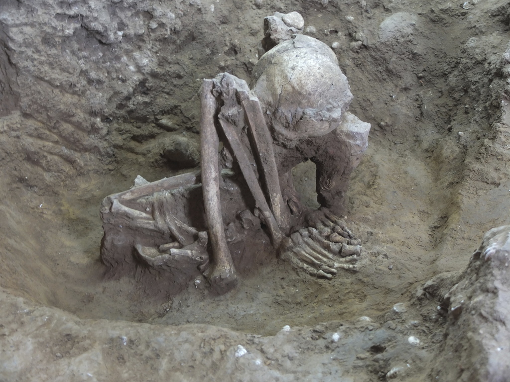 This undated photo provided by Hirofumi Matsumura shows a 9,000-year-old mummy in Guangxi, China, in a squatting position. (Hirofumi Matsumura via AP)