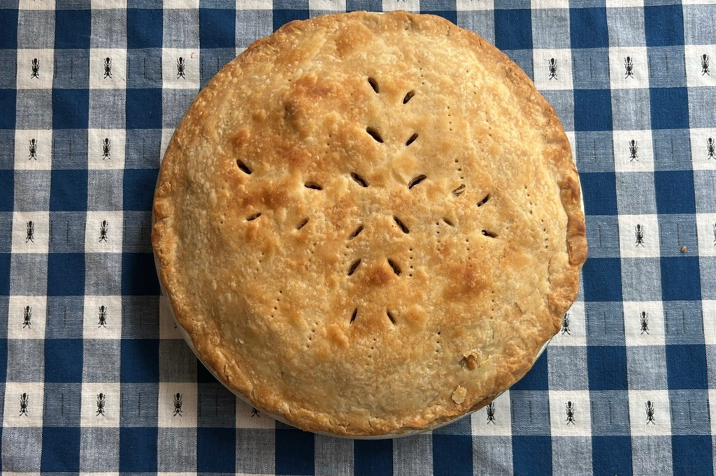 A freshly baked apple pie sits on a tablecloth in Marlborough, Massachusetts on June 26, 2026. (AP Photo/Bev Biller)