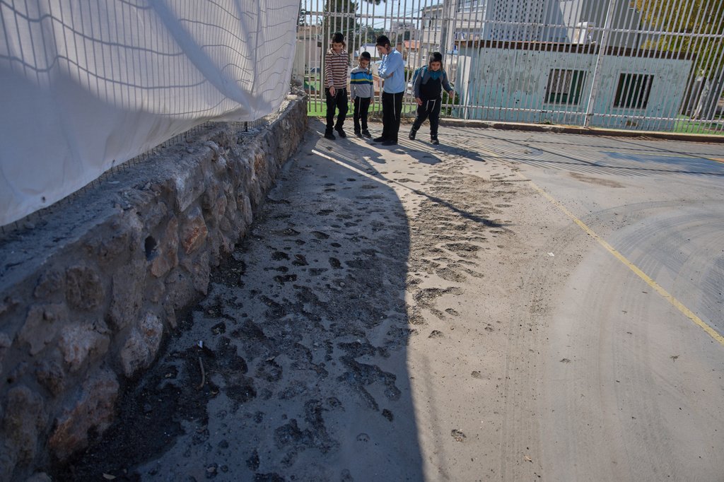 Children look at a damaged play ground hit yesterday by projectiles launched from Lebanon in Nahariya, northern Israel, Sunday, April 12, 2026. (AP Photo/Ariel Schalit)
