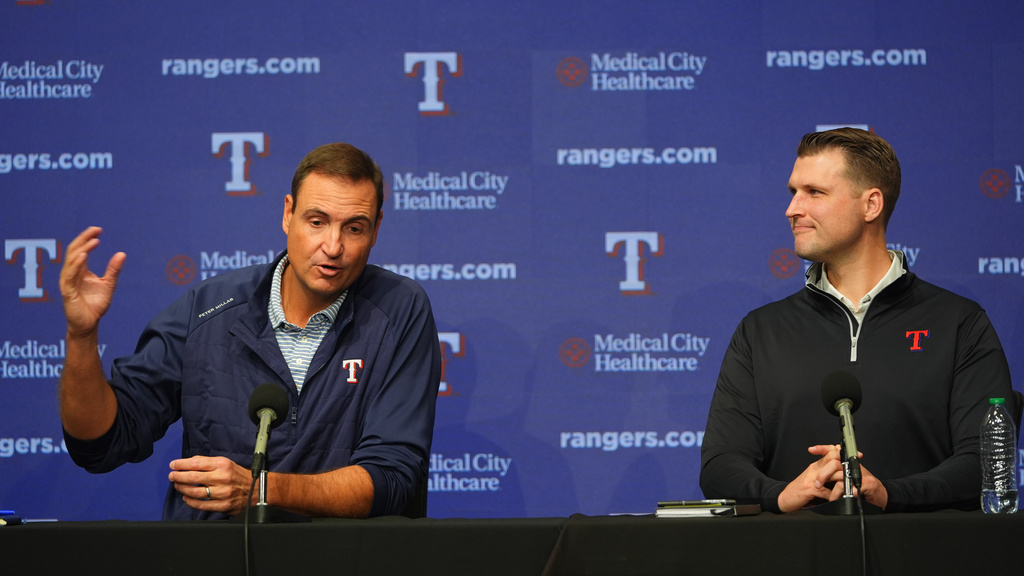 Texas Rangers president of baseball operations Chris Young, left, speaks as general manager Ross Fenstermaker looks on during an end of regular season baseball news conference, Friday, Oct. 3, 2025, in Arlington, Texas. (AP Photo/LM Otero)