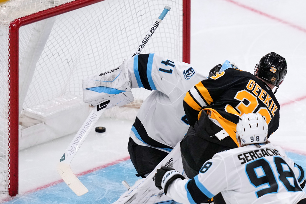 Boston Bruins center Morgan Geekie (39) shoots the puck past Utah Mammoth goaltender Vitek Vanecek (41), for his second goal of the night, during the second period of an NHL hockey game, Tuesday, Dec. 16, 2025, in Boston. (AP Photo/Charles Krupa)