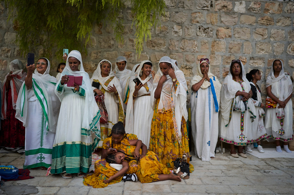 Ethiopian Orthodox Christian worshippers gather for celebrations on the eve of the Meskel holiday at the Ethiopian monks' village, Deir Al‑Sultan, located on the rooftop of the Church of the Holy Sepulcher in Jerusalem's Old City, Saturday, Sept. 26, 2026. (AP Photo/Ohad Zwigenberg)