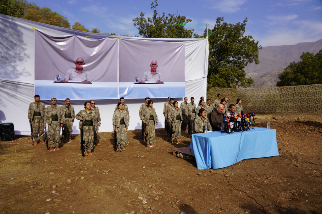 FILE - Kurdistan Workers' Party (PKK) fighters, who reportedly withdrew from Turkey with their weapons, stand to attention during a ceremony in the Qandil area of northern Iraq, щт Oct 26, 2025. (AP Photo/Rashid Yahya, File)
