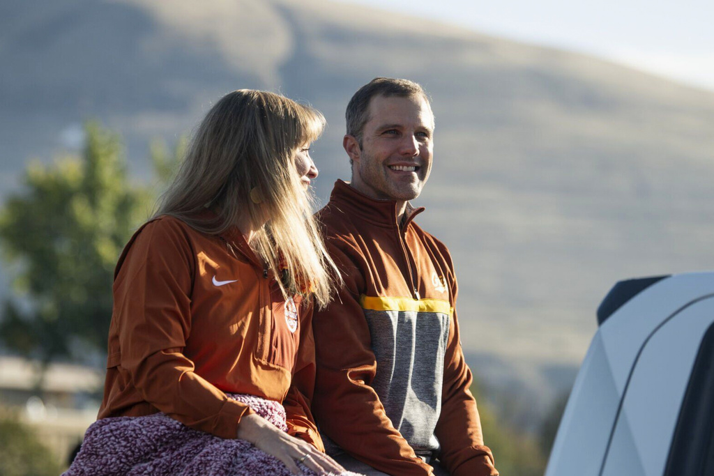 FILE - University of Montana President Seth Bodnar, right, and his wife, Dr. Chelsea Bodnar, ride in the university's homecoming parade in Missoula, Mont., Saturday, Oct. 11, 2025. (Ben Allan Smith/The Missoulian via AP, File)