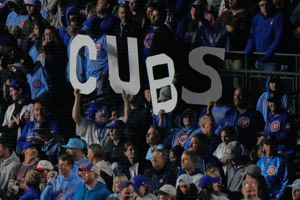 Fans cheer at Wrigley Field during the seventh inning of Game 3 of baseball's National League Division Series between the Milwaukee Brewers and the Chicago Cubs Wednesday, Oct. 8, 2025, in Chicago. (AP Photo/Nam Huh)
