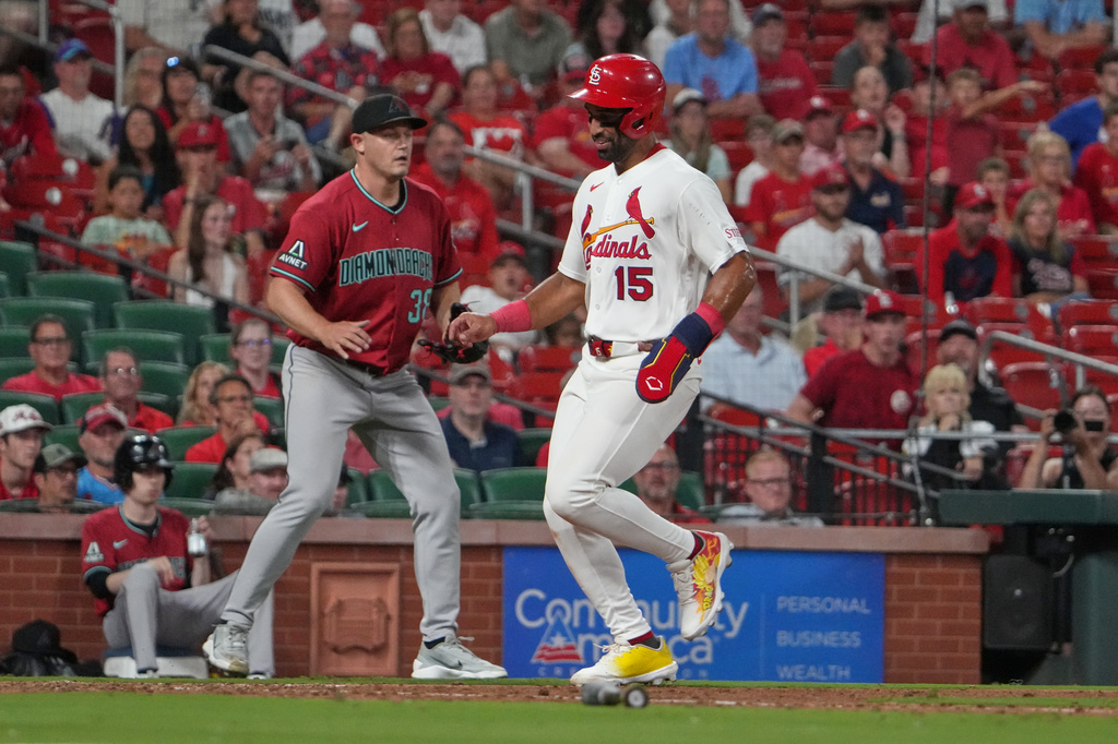 St. Louis Cardinals' José Fermín (15) scores past Arizona Diamondbacks pitcher Paul Sewald during the ninth inning of a baseball game Tuesday, June 23, 2026, in St. Louis. (AP Photo/Jeff Roberson)