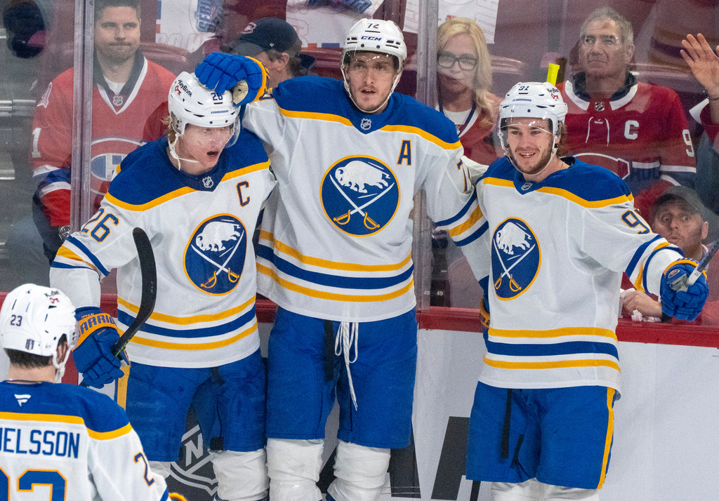 Buffalo Sabres' Tage Thompson, center, celebrates his goal with teammates Rasmus Dahlin (26) and Josh Doan (91) during the first period in Game 3 in a second-round NHL hockey Stanley Cup playoff series against the Montreal Canadiens in Montreal, Sunday, May 10, 2026. (Christinne Muschi/The Canadian Press via AP)