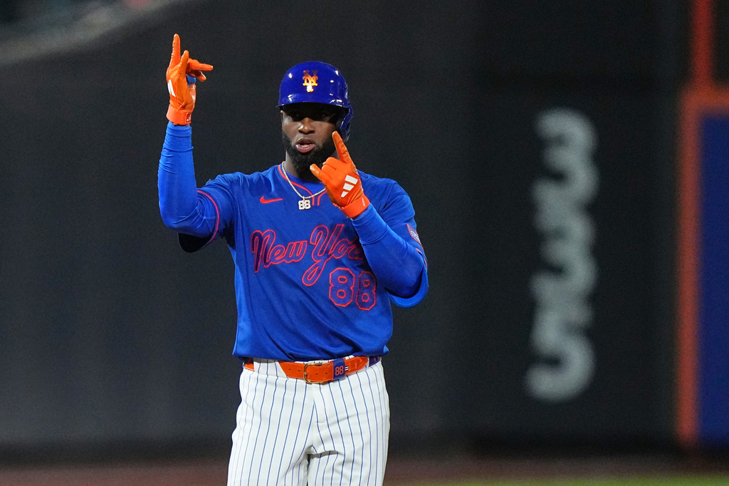 New York Mets' Luis Robert Jr. gestures to teammates after hitting a two-run single during the eighth inning of a baseball game against the Miami Marlins Thursday, July 30, 2026, in New York. (AP Photo/Frank Franklin II)