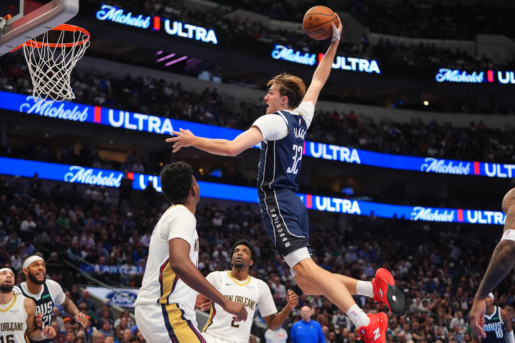 Dallas Mavericks forward Cooper Flagg (32) comes in for slam dunk against the New Orleans Pelicans during the second half of an NBA Cup basketball game in Dallas, Friday, Nov. 21, 2025. (AP Photo/LM Otero)