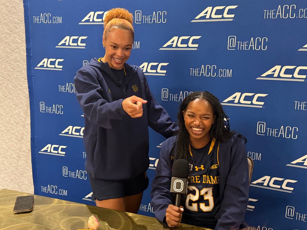 Notre Dame senior guard Hannah Hidalgo, left, jokes with a reporter alongside teammate Madison St. Rose during an interview session at the Atlantic Coast Conference's preseason basketball media days Monday, Oct. 5, 2026, in Charlotte, N.C. (AP Photo/Aaron Beard)