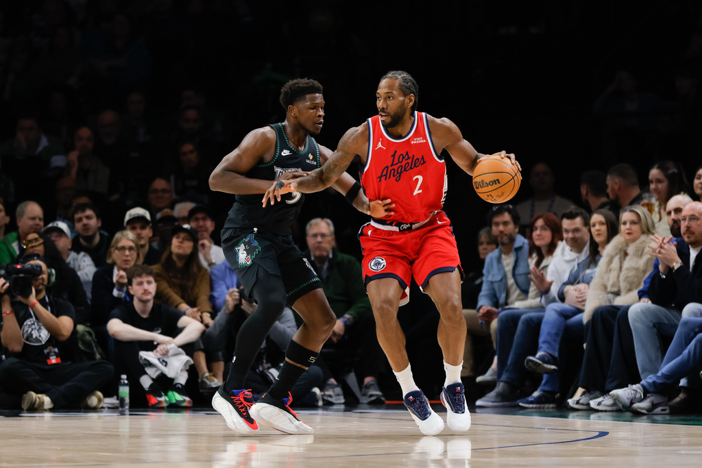 Los Angeles Clippers forward Kawhi Leonard (2) dribbles while Minnesota Timberwolves guard Anthony Edwards, left, defends during the first half of an NBA basketball game, Sunday, Feb. 8, 2026, in Minneapolis. (AP Photo/Bailey Hillesheim)