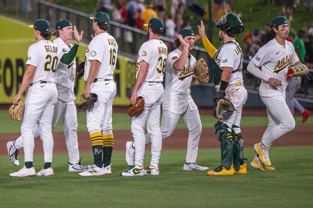 The Athletics celebrate after winning a baseball game against the Los Angeles Angels in West Sacramento, Calif., Thursday, June 18, 2026. (AP Photo/Nic Coury)