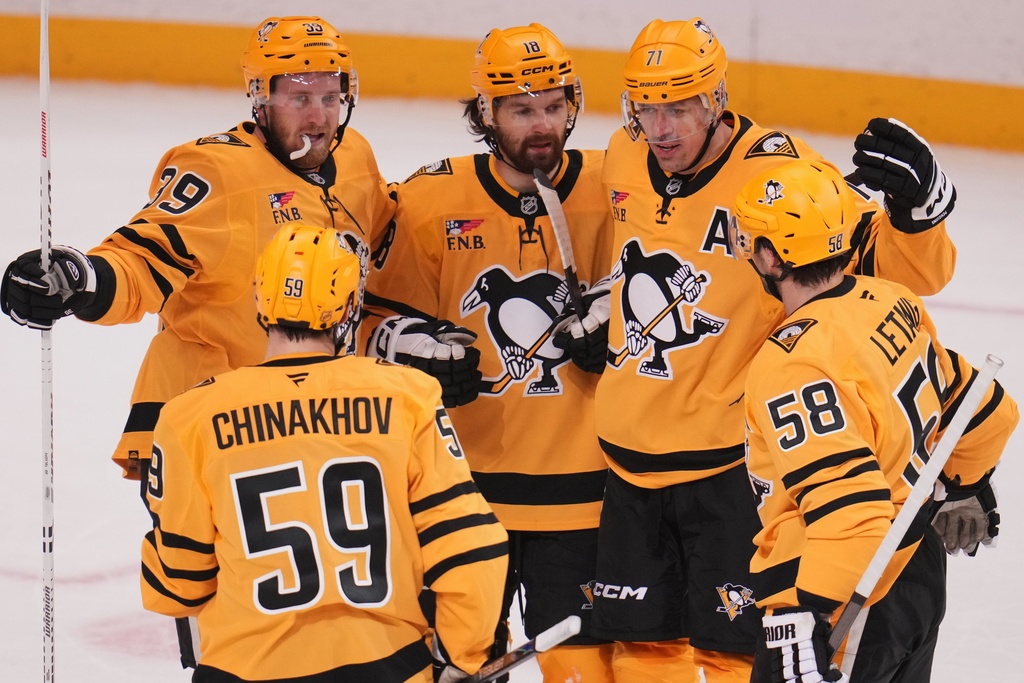 Pittsburgh Penguins' Tommy Novak (18) celebrates his goal during the first period of an NHL hockey game against the New Jersey Devils in Pittsburgh, Thursday, Feb. 26, 2026. (AP Photo/Gene J. Puskar)