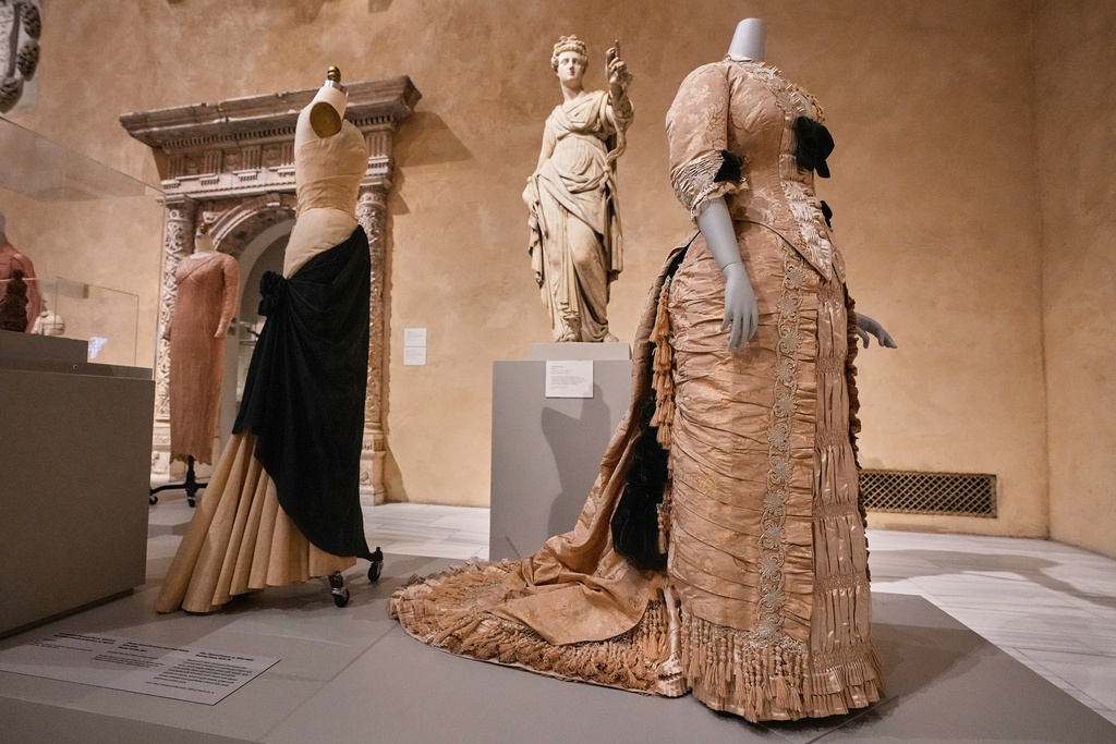 "Bustle" by Charles James, right, is displayed at the announcement, at the Metropolitan Museum of Art, in New York, Monday, Nov. 17, 2025, about the next spring fashion exhibit "Costume Art," which is set to launch at the Met Gala in 2026. (AP Photo/Richard Drew)