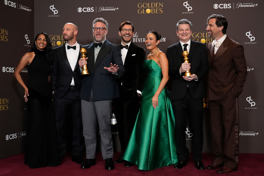 Frida Perez, from left, Evan Goldberg, Seth Rogen, Peter Huyck, Chase Sui Wonders, Alex Gregory, and James Weaver pose in the press room with the award for best television series – musical or comedy for "The Studio" during the 83rd Golden Globes on Sunday, Jan. 11, 2026, at the Beverly Hilton in Beverly Hills, Calif. (AP Photo/Chris Pizzello)