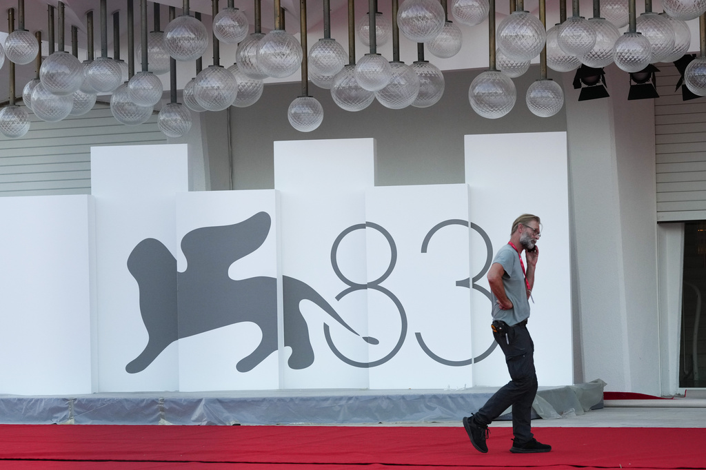 A worker makes a telephone call on the red carpet prior to the 83rd edition of the Venice Film Festival in Venice, Italy, on Monday, Aug. 31, 2026. (Photo by Alessandra Tarantino/Invision/AP)