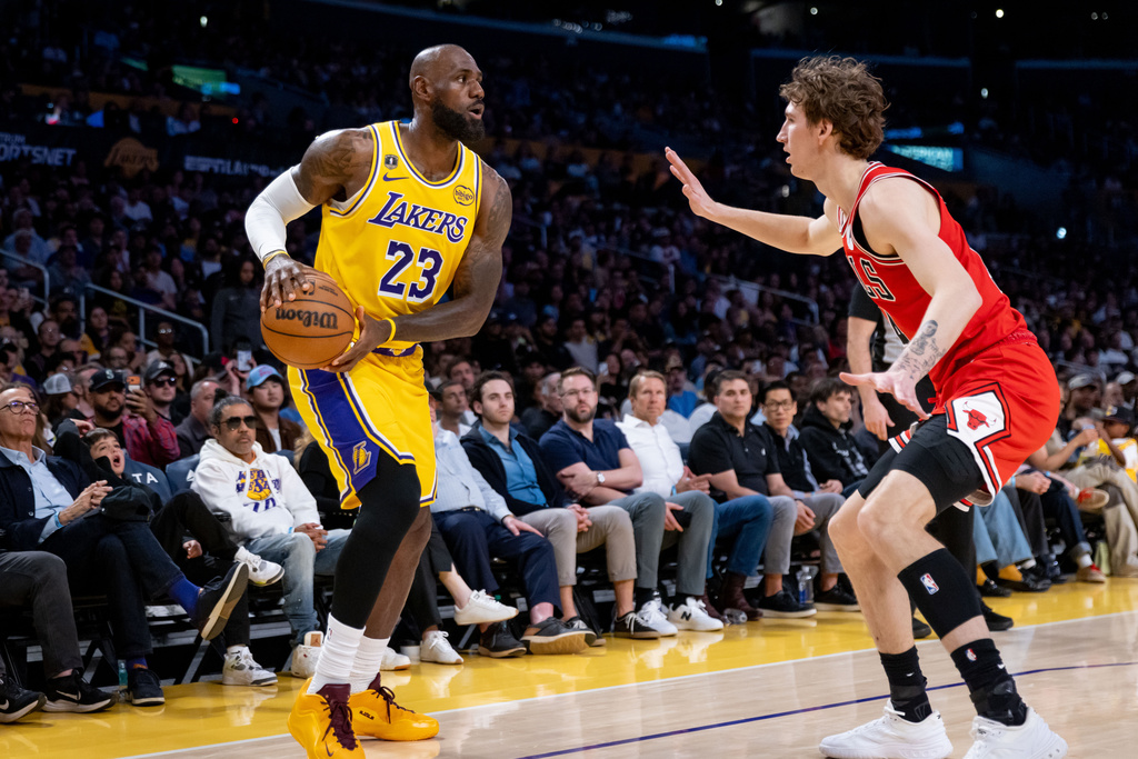 Los Angeles Lakers forward LeBron James (23) is defended during the first half of an NBA basketball game against the Chicago Bulls, Thursday, March 12, 2026, in Los Angeles. (AP Photo/Ethan Swope)