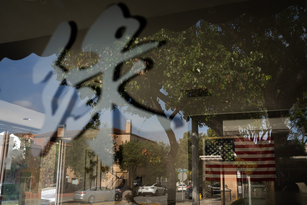 An American flag hangs inside a cafe in Arcadia, Calif., Tuesday, May 12, 2026, in the city whose former mayor, Eileen Wang, pleaded guilty to being an illegal agent of the Chinese government. (AP Photo/Jae C. Hong)