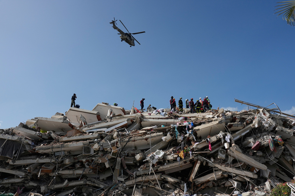 Rescue workers search through the rubble three days after earthquakes struck Catia la Mar, Venezuela, Saturday, June 27, 2026. (AP Photo/Fernando Vergara)