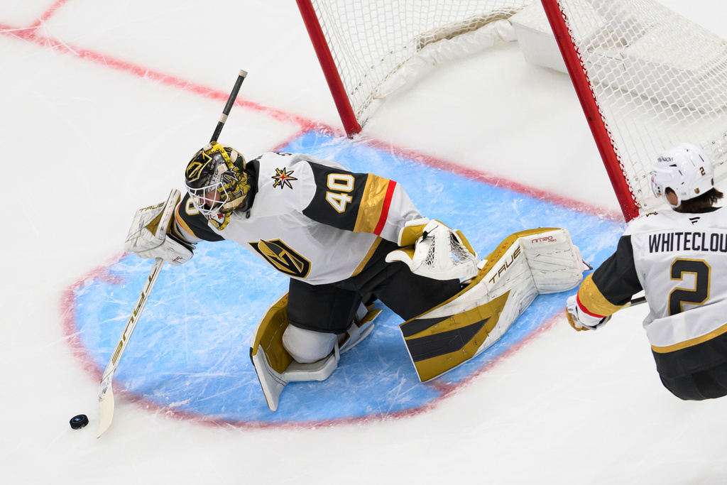 Vegas Golden Knights goaltender Akira Schmid (40) steers the puck away from the net with his stick during the first period of an NHL hockey game against the Utah Mammoth, Thursday, Nov. 20, 2025, in Salt Lake City, Utah. (AP Photo/Tyler Tate)